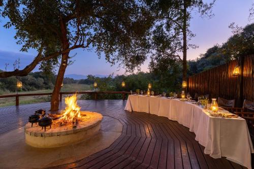 a table set up for a wedding with a fire pit at Karongwe - Kuname Safari Lodge in Hoedspruit