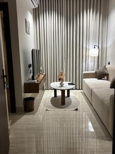 a living room with a couch and a coffee table at شقة بحي البرج جديدة in Al Kharj
