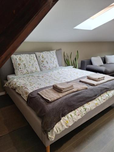 a bedroom with a bed with towels on it at Szmer Olzy Apartament in Istebna