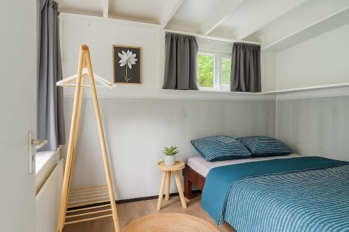a bedroom with a bed and a ladder in it at Zenda's natuurhuisje in Lanaken