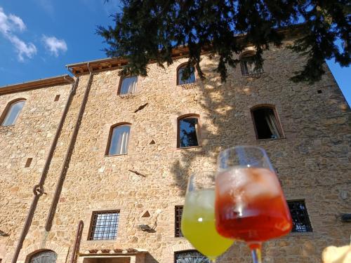 two wine glasses sitting in front of a building at Rocca degli Olivi in San Gimignano