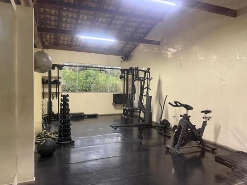 a gym with bikes and exercise equipment in a room at Flat Village - Aldeia das Águas F305 in Barra do Piraí