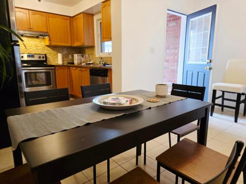 a kitchen with a table with a plate of food on it at Semi-Private Townhouse - 3 Bedrooms - 4 beds - Free Parking, Wifi, Netflix in Toronto
