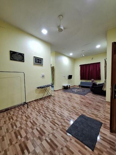 a living room with a couch and a table at DTM Homestay 1 in Tanah Merah