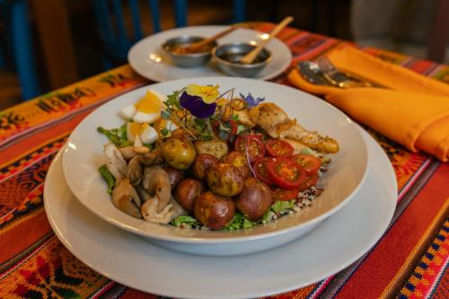 a white plate of food on a table at Amerindia in Cusco