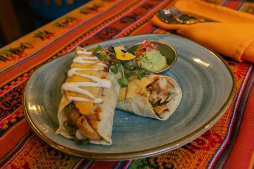 a plate with two tacos on a table at Amerindia in Cusco