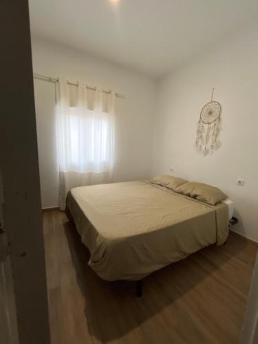 a bedroom with a bed in a white room at Alojamiento en Murchante in Murchante