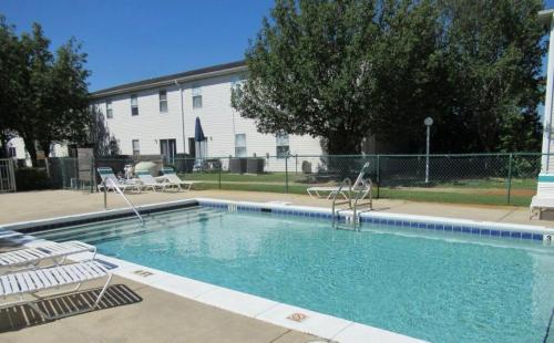 a swimming pool with two chairs at Beach Breeze Getaway in Destin