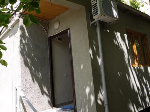 a house with a window on the side of it at Family Hotel Mountain Scream in Tbilisi City