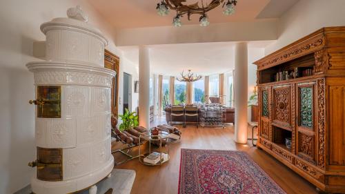 a living room with a large white stove in a room at Villa Victoria in Fischerndorf