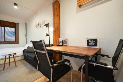 a room with a desk and chairs and a bed at Dec Room at Shine Haus BangSue in Bang Su