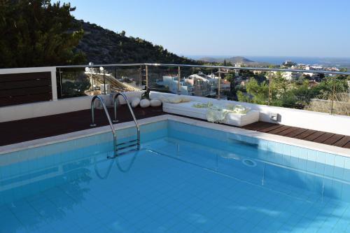 a swimming pool on top of a building at Panorama Penthouse & Studios in Athens