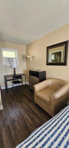 a living room with a couch and a table at Fair Isle Motel & The Nest in Whycocomagh