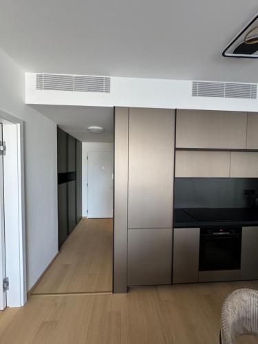 a living room with white walls and a kitchen at SKY PARK no compromise with parking in Nivy