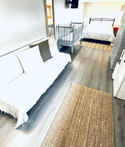a living room with a bed and a rug at Vasiliki Guest House in Kalamata