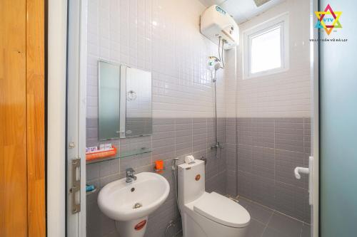 a bathroom with a toilet and a sink at Villa Tuan Vu Da Lat - Free to Be You in Da Lat
