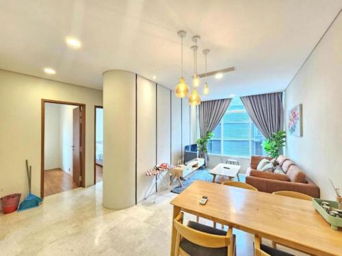 a living room with a table and a couch at Sky Suites KLCC CityLights in Kuala Lumpur
