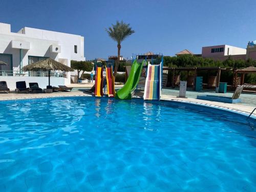 a swimming pool with a water slide in a resort at Badawia Sharm Resort in Sharm El Sheikh