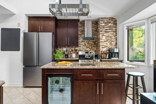 a kitchen with wooden cabinets and a refrigerator at Theater*2 Game Rooms *Sauna *Hot Tub*Fall Specials in Blakeslee