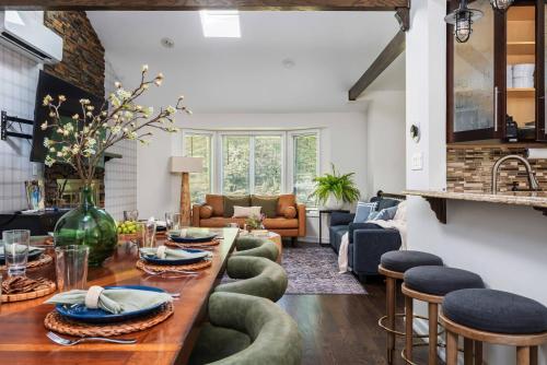 a living room with a long table and green chairs at Theater*2 Game Rooms *Sauna *Hot Tub*Fall Specials in Blakeslee