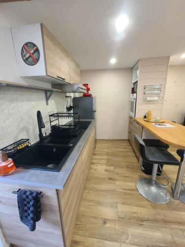 a kitchen with a sink and a counter top at Le Studio de la Baume in Sisteron