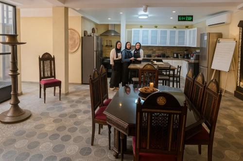 a group of three women standing in a kitchen at Gamaleya Boutique Hotel in Cairo