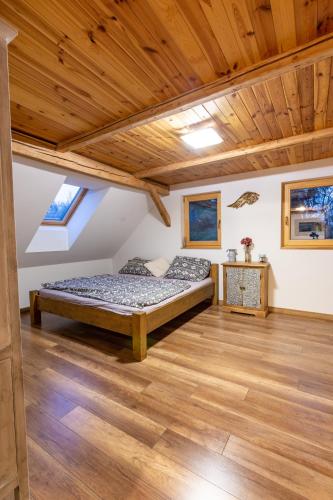 a bedroom with two beds and a wooden ceiling at Chalet Malá Strana in Lučany nad Nisou