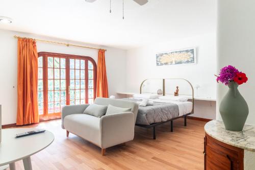 a bedroom with a bed and a vase of flowers at Los Penones Experiences A - Solo Adultos in El Sao