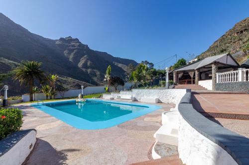 a swimming pool with mountains in the background at Los Penones Experiences A - Solo Adultos in El Sao