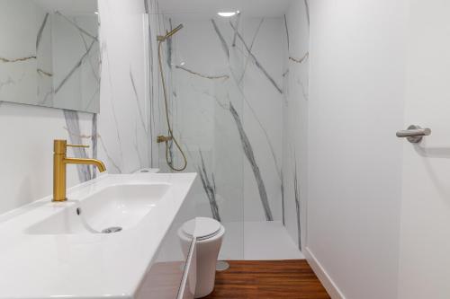 a white bathroom with a tub and a sink at Los Penones Experience B - Solo Adultos in El Sao