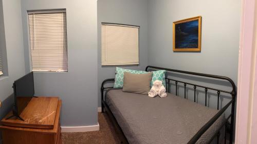 a small bedroom with a bed with a teddy bear on it at The Woodward Unit D in Dahlonega