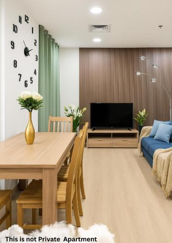 a living room with a table and a television at The Marina Quite Kingdom in Dubai