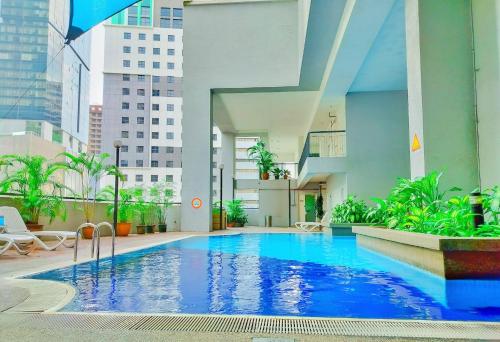 a large swimming pool in the middle of a building at Seri Suites KLcc in Kuala Lumpur