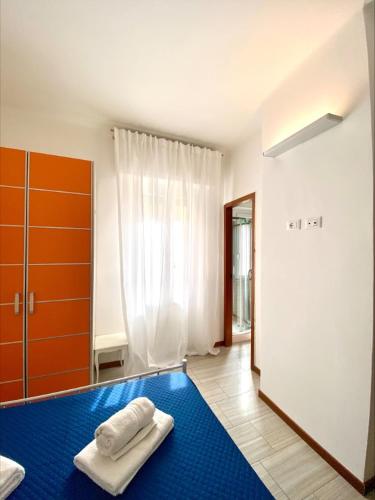 a bedroom with a blue rug and a large window at La Nena Appartamenti - Home in the heart of the city center in La Spezia