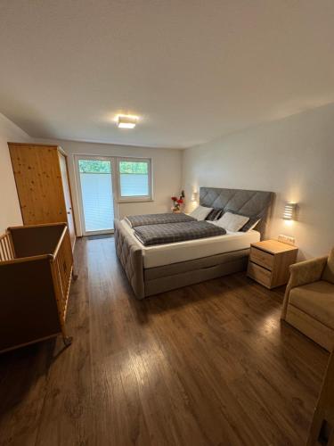 a large bedroom with a bed and a couch at Haus Jäger in Lermoos
