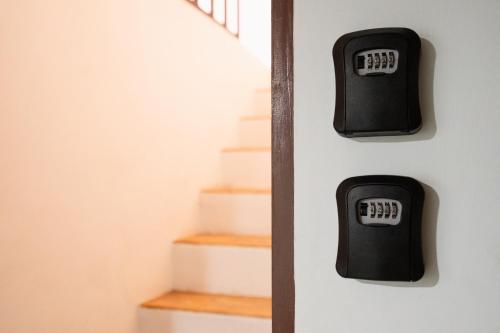 a set of stairs with a clock on the wall at Dec Room at Shine Haus BangSue in Bang Su