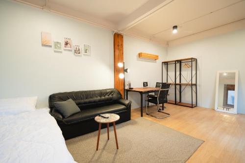 a living room with a couch and a table at Dec Room at Shine Haus BangSue in Bang Su