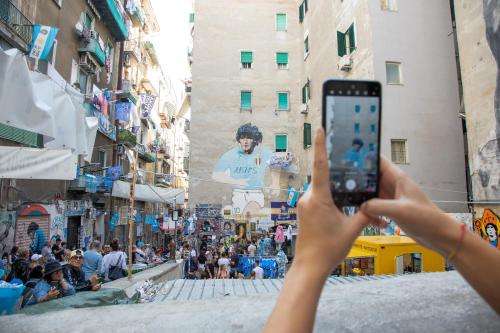 a person taking a picture of a street with a cell phone at Napoli in relax in Naples