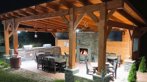 a patio with a fireplace and tables and chairs at Candlewood Suites Washington North by IHG in Washington