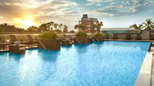 a large swimming pool on top of a building at Holiday Inn Cochin by IHG in Cochin