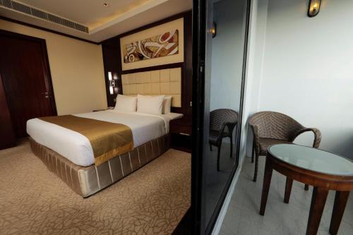 a hotel room with a bed and a table at Holiday Inn Cochin by IHG in Cochin