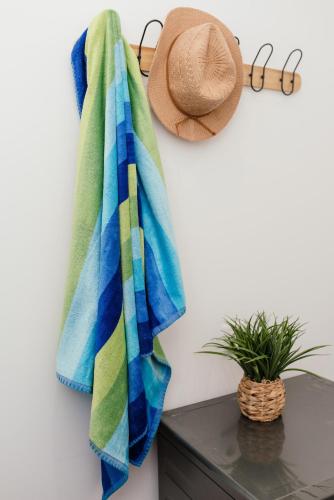a towel hanging on a wall next to a hat at Casa Piquita in Estreito da Calheta