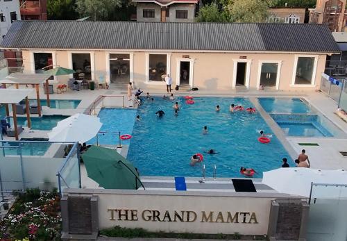 a group of people swimming in a swimming pool at The Grand Mamta in Srinagar
