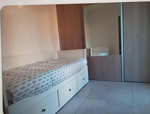 a small bedroom with a bed and a closet at Le Baou fully renovated 2025 in Sanary-sur-Mer
