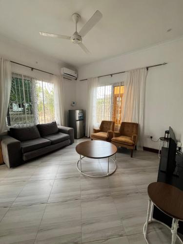 a living room with a couch and a table at Private Villa in Bagamoyo in Bagamoyo