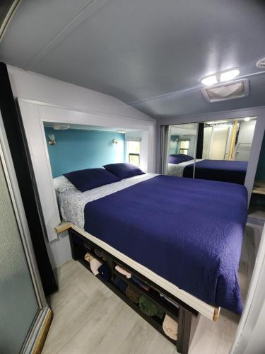 a bedroom with a purple bed in a room at Shroom life farm Chicken shack in North Fort Myers