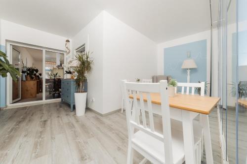 a living room with a table and a dining room at AZUL in Zambujeira do Mar