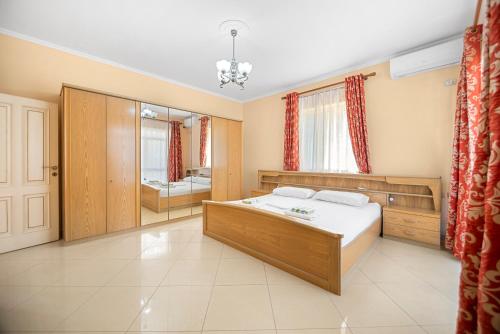 a bedroom with a bed and a bathroom at Vila Rroshaj in Tirana