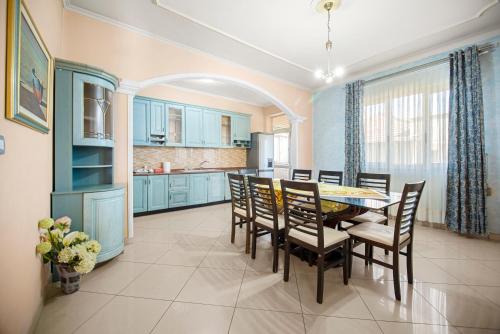a kitchen and dining room with a table and chairs at Vila Rroshaj in Tirana