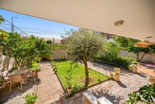 an overhead view of a patio with a tree at Vila Rroshaj in Tirana